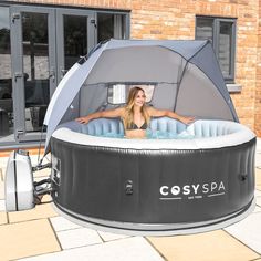 a woman sitting in an inflatable hot tub