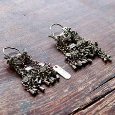 These dangle earrings are antiques that originate from the Qing Dynasty, where a noble woman would have worn an intricate design such as this for a special occasion.Antique stock, made by hand in the late 19th or early 20th century. Length 3 1/2 to 4 1/2 inches.