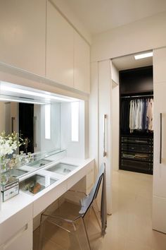 a dressing room with mirrors and lights on the wall