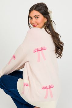 Pink Bows Button Cardi, Cream - New Arrivals - The Blue Door Boutique Spring Long Sleeve Sweater With Bow, Long Sleeve Sweater With Bow For Spring, Pink Feminine Sweater For Loungewear, Pink Bow Top For Fall, Pink Tops For Winter Daywear, Pink Winter Daywear Tops, Pink Winter Tops For Daywear, Table La, Pink Bows