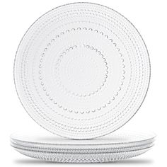 three white plates stacked on top of each other, with circles in the middle and bottom