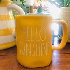 a yellow coffee mug sitting on top of a wooden table