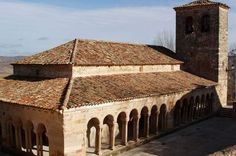 an old building with two towers and arches