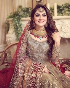 a woman in a bridal outfit posing for the camera