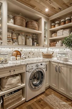 a washer and dryer in a kitchen with lots of shelves on the wall