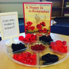 there is a tray that has different items in it on the table and a book about poppys