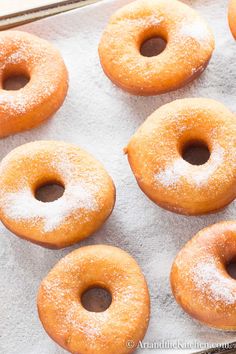 there are many donuts that are on the baking sheet and ready to be eaten