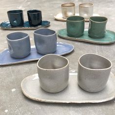 some cups and saucers are sitting on a table