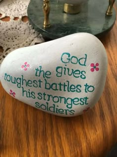 a rock that says god the gives tough battles to his strongest soldiers on it