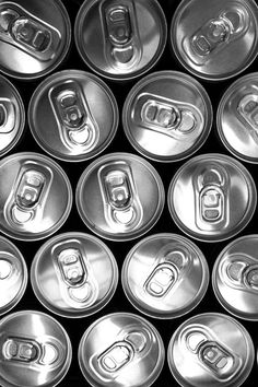 many silver soda cans are stacked together