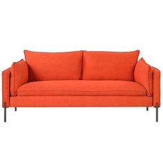 an orange couch sitting on top of a white floor