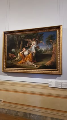 a painting hanging on the wall in a museum