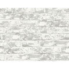 an old brick wallpaper with white paint on the top and grey bricks below it