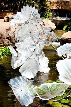 some glass flowers are floating in the water