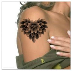 a woman's arm with a flower tattoo on the back of her shoulder,