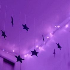 stars hanging from the ceiling in a purple room