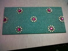 there is a green place mat with flowers and stones on the top, along with other items