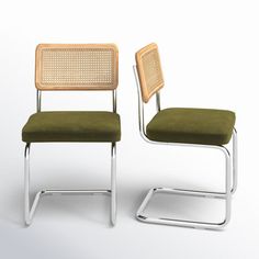 two chairs sitting side by side in front of a white background, one with a green seat and the other without