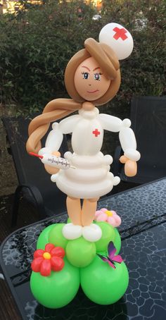 a balloon sculpture on top of a table in the shape of a nurse