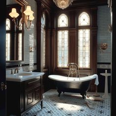 an old fashioned bathtub in a bathroom with chandelier above it and stained glass windows