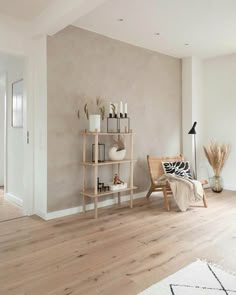 a living room with white walls and wooden floors