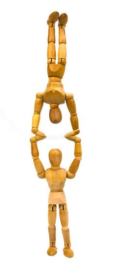 a wooden toy standing in the shape of a man with two hands on his hips