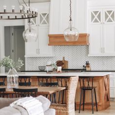 the kitchen is clean and ready to be used for cooking or dining room furniture, as well as an island with stools