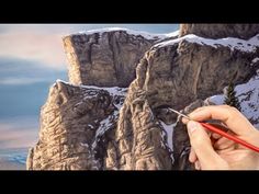 someone is painting the mountains with colored pencils