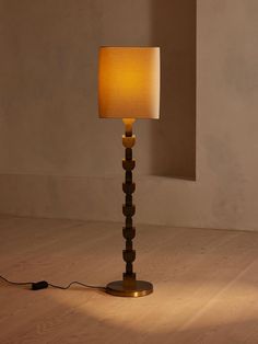 a lamp that is on top of a wooden floor