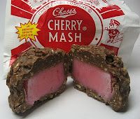 a bag of cherry mash sitting on top of a white table next to a piece of chocolate