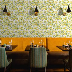 a restaurant with yellow booths and green chairs