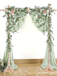 an arch decorated with flowers and greenery