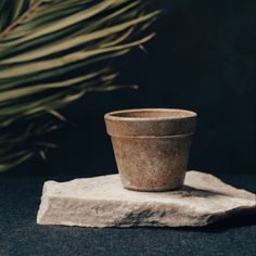 a stone bowl sitting on top of a rock