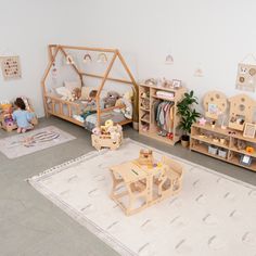 a child's playroom with toys and bookshelves on the floor in front of it