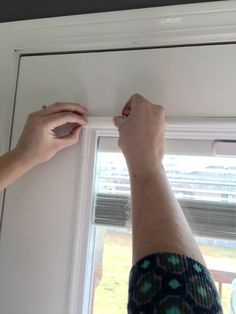 a person is working on the window sill