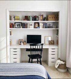 a bedroom with a bed, desk and bookshelf