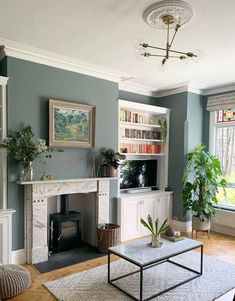 a living room filled with furniture and a fire place in front of a tv mounted on a wall