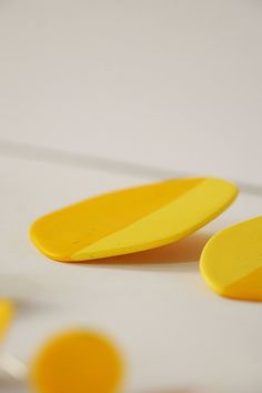 three yellow circles sitting on top of a white surface