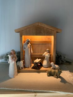 a nativity scene with figurines in front of a manger crib