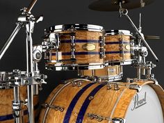 a close up of a drum set on a black background with blue stripes and silver hardware