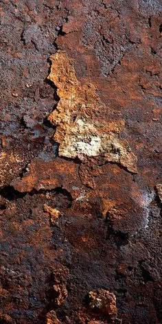 an old rusted surface with white and yellow patches