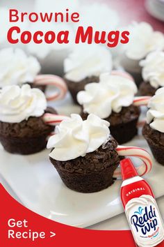 chocolate cupcakes with white frosting and peppermint candy canes on a plate