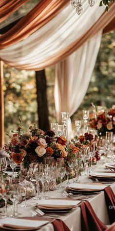 the table is set with wine glasses, plates and place settings for an elegant wedding