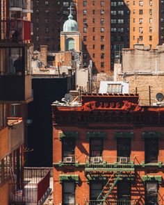 an old building is surrounded by tall buildings