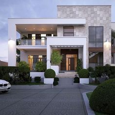 a car is parked in front of a modern house