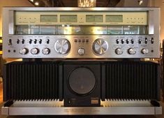 an old fashioned radio sitting on top of a shelf in a room with other items