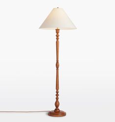 a wooden lamp with a white shade on the base and a cord attached to it