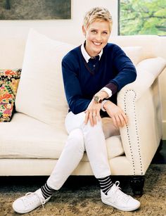 a woman sitting on top of a white couch