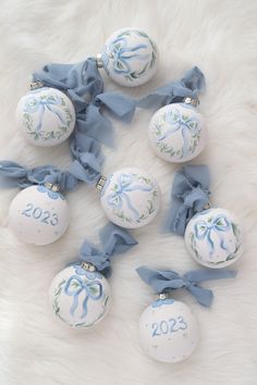 white and blue ornaments with bows on them