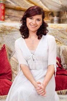 a woman sitting on top of a red couch